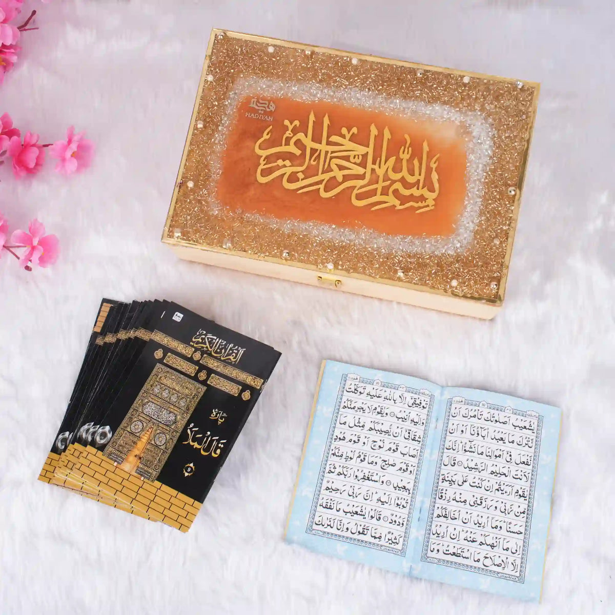 White Quran box with intricate gold design and pink flowers