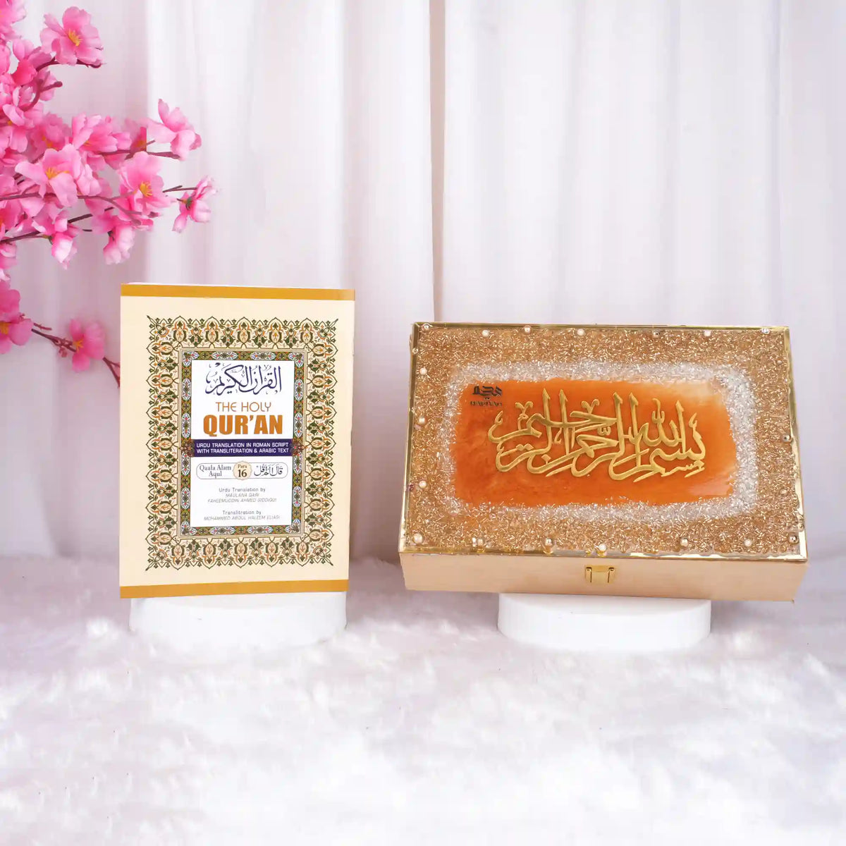 Golden glittered Quran box with Arabic calligraphy and pink flowers