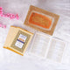 Golden glittered Quran box with Arabic calligraphy and pink flowers