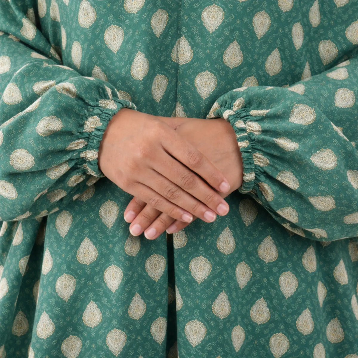 Close-up of Prayer Dress 5 sleeve cuffs with elastic finish, featuring gold paisley print for a premium and comfortable modest wear.