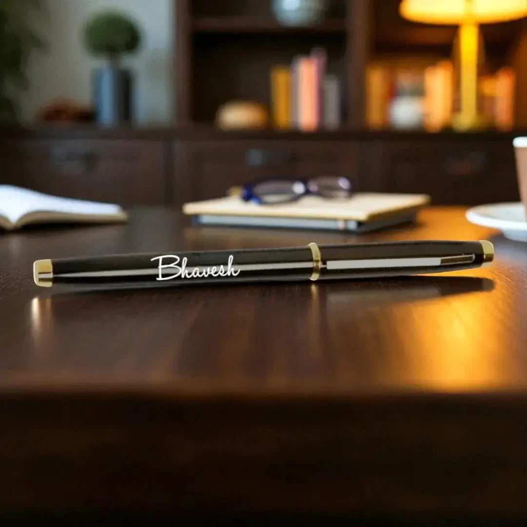 Gold Roller Metal Pen - Luxury Writing | Precision Design, personalized with the name 'Bhavesh', placed on a wooden desk in an office setting. Main image
