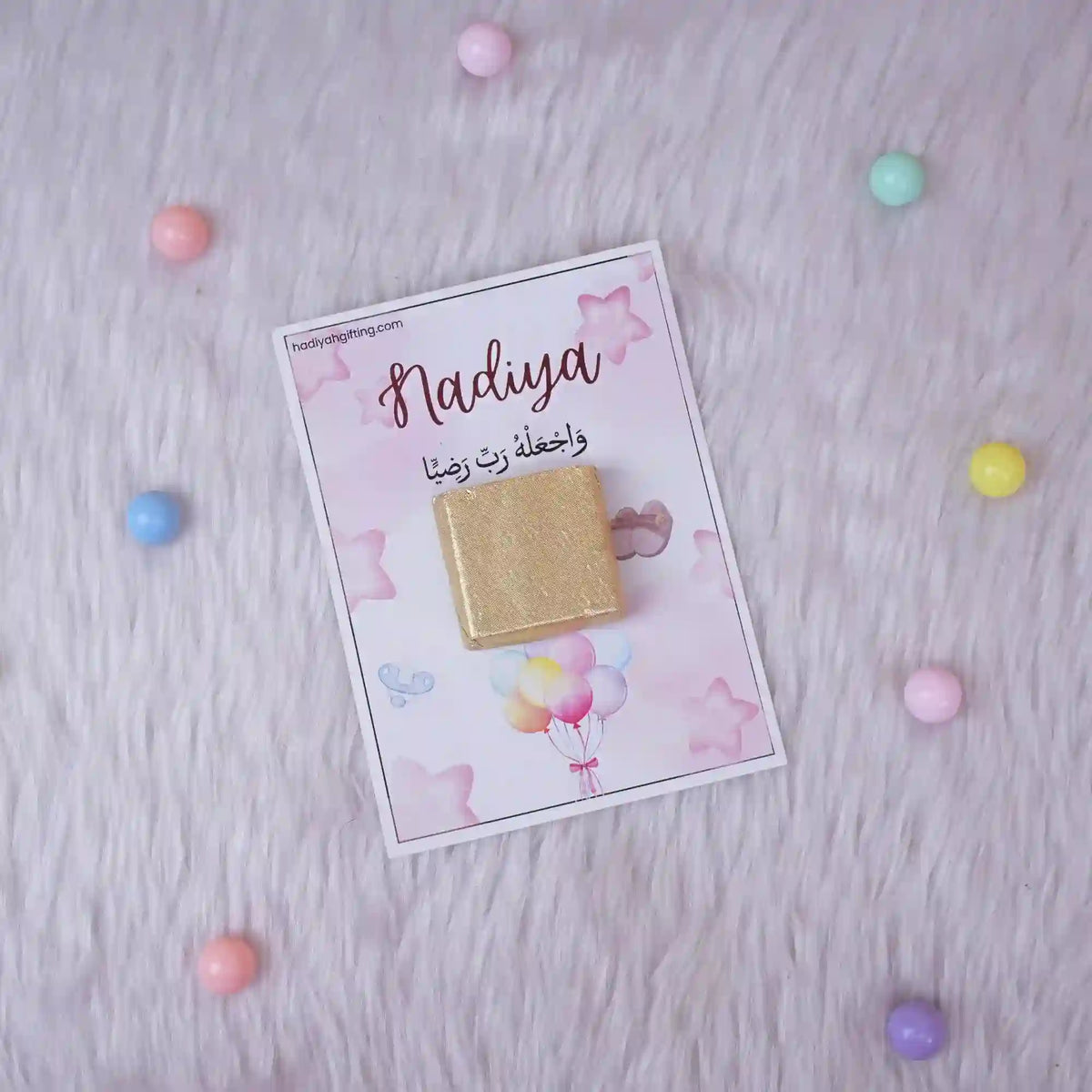 Single Aqiqah Sweet Blessings Favor with gold chocolate on a pink card with balloons and stars, designed for personalized Aqiqah gifts.