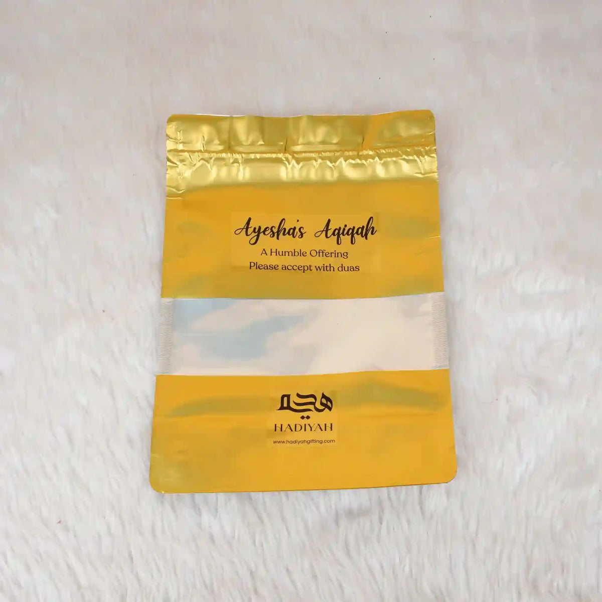 Aqiqah Meat Packet with gold resealable pouch labeled 'Ayesha's Aqiqah' for wedding favors. Customizable and hygienically packed for easy distribution.