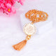 Close-up of golden crystal tasbeeh with Arabic medallion and tassel, from the Bling Collection Quran Gift Set.