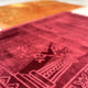 Detailed texture of maroon prayer mat from Golden & Maroon Couple Janamaz Set, highlighting plush fabric and elegant Islamic design.