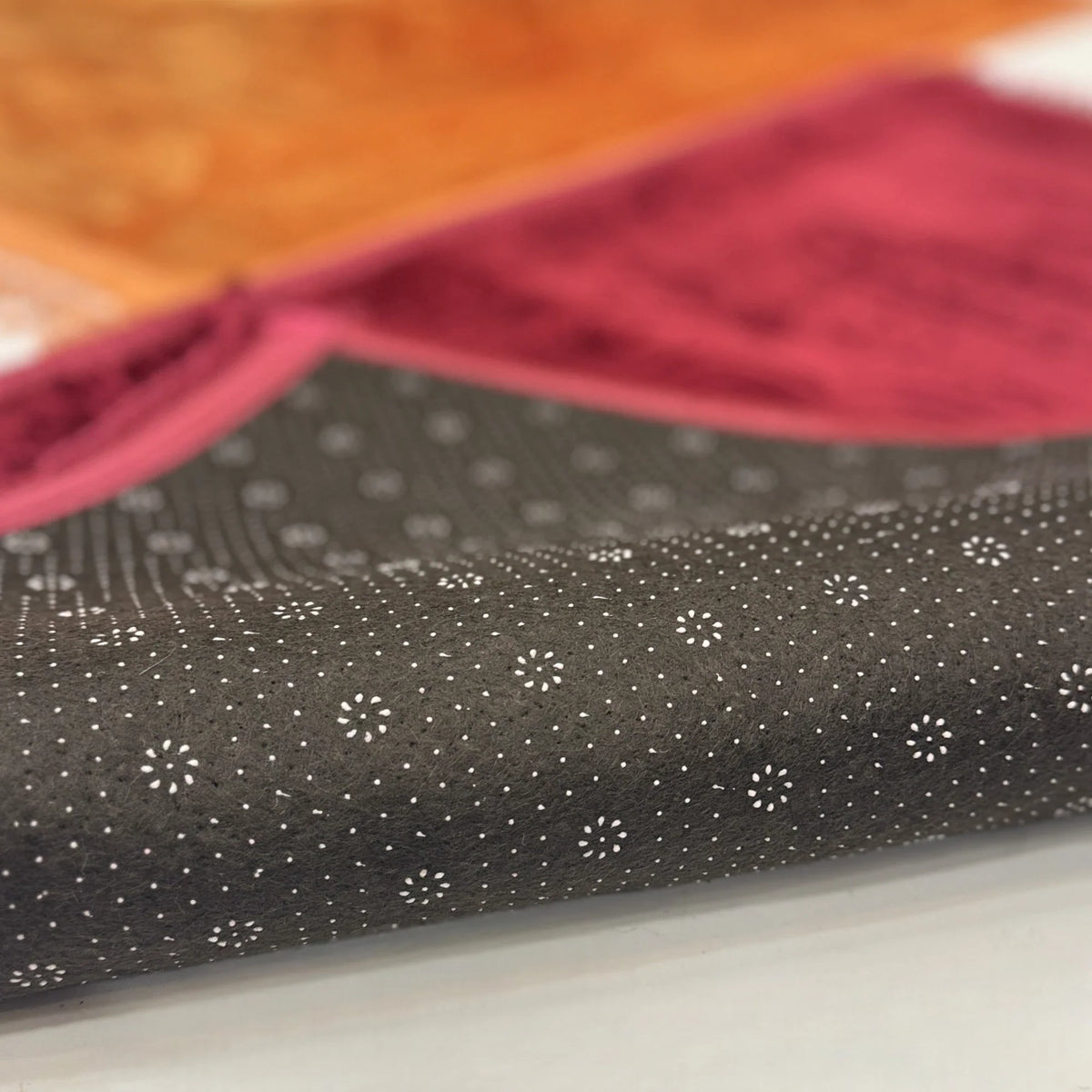 Non-slip backing of Golden & Maroon Couple Janamaz Set showing dotted grip texture for secure and comfortable prayer experience.