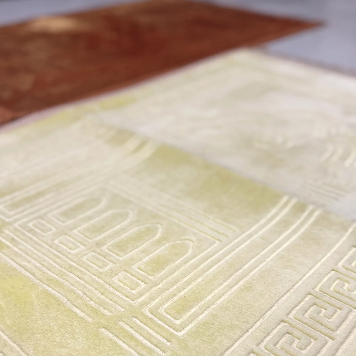 Detailed texture of the offwhite prayer mat from the golden offwhite couple janamaz set, showcasing premium quality and embossed Islamic motifs.