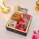 Gift box with Ramadan-themed items including a rosary, cookies, and a 'Ramadan Mubarak' decoration on a light background.