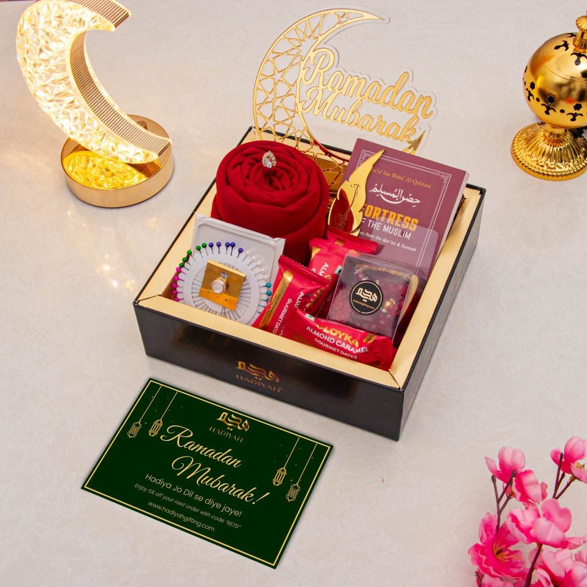 Golden Ramadan Mubarak Hamper with red hijab, Islamic book, sweets, and greeting card, ideal for luxury Ramadan gift delivery.