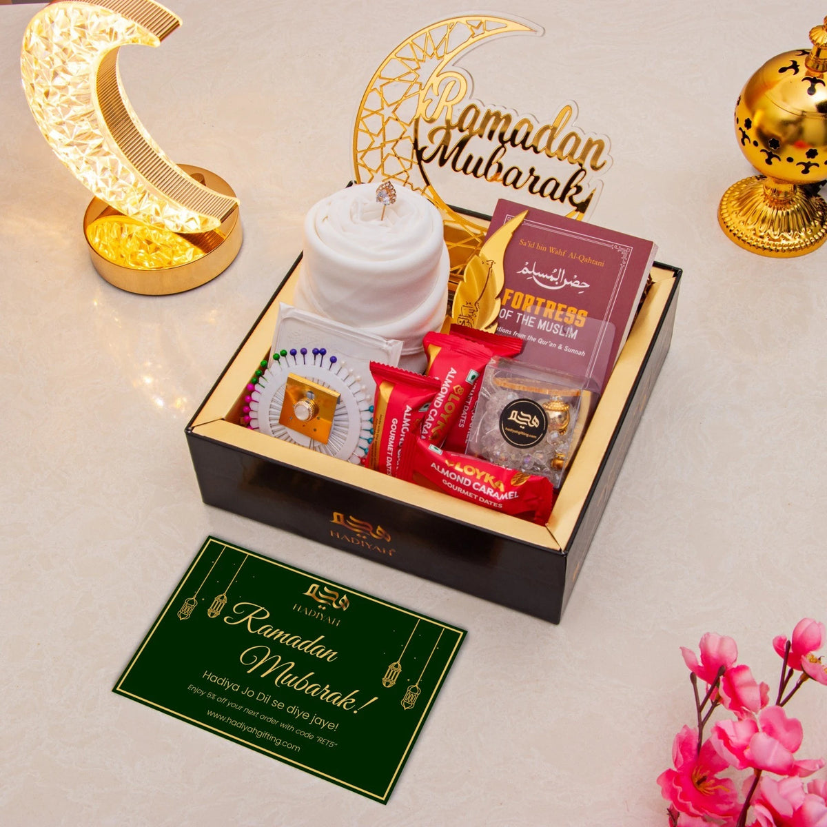 Golden Ramadan Mubarak Hamper - Ramadan Gift Hamper with white hijab, Islamic book, gourmet snacks, and greeting card for Eid.
