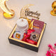Elegant Golden Ramadan Mubarak Hamper featuring white hijab, prayer book, sweets, and decorative Ramadan elements for gifting.