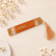 Islamic personalized bookmark in golden resin with elegant Arabic calligraphy and gold tassel, ideal as a wedding favor or sacred text accessory.