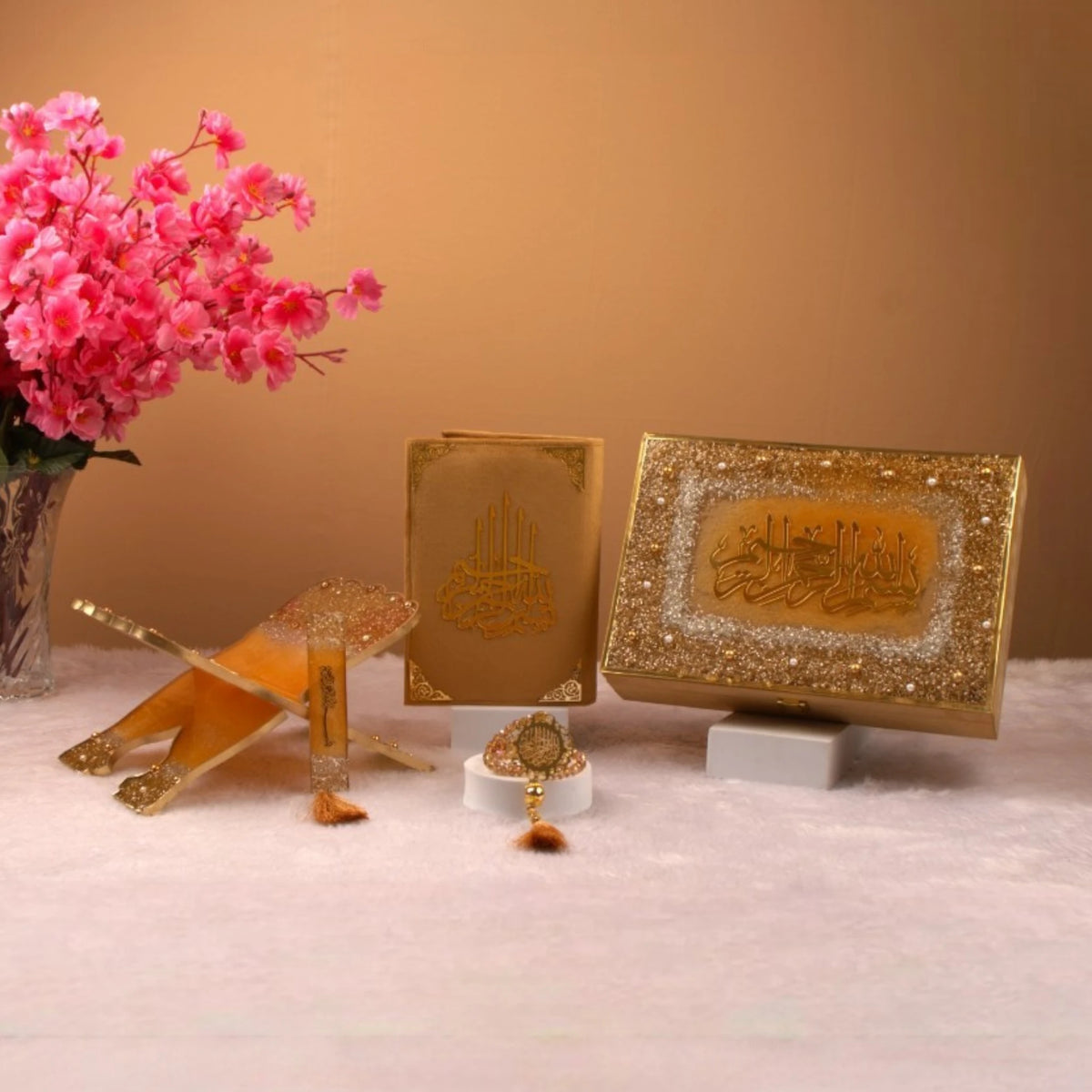 Premium Golden Sequence Rehal Hamper featuring Quran, glitter Rehal, and tasbeeh, displayed elegantly with floral decor. Perfect for gifting occasions.