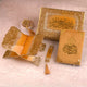 Decorative set with gold and orange elements on a light pink background