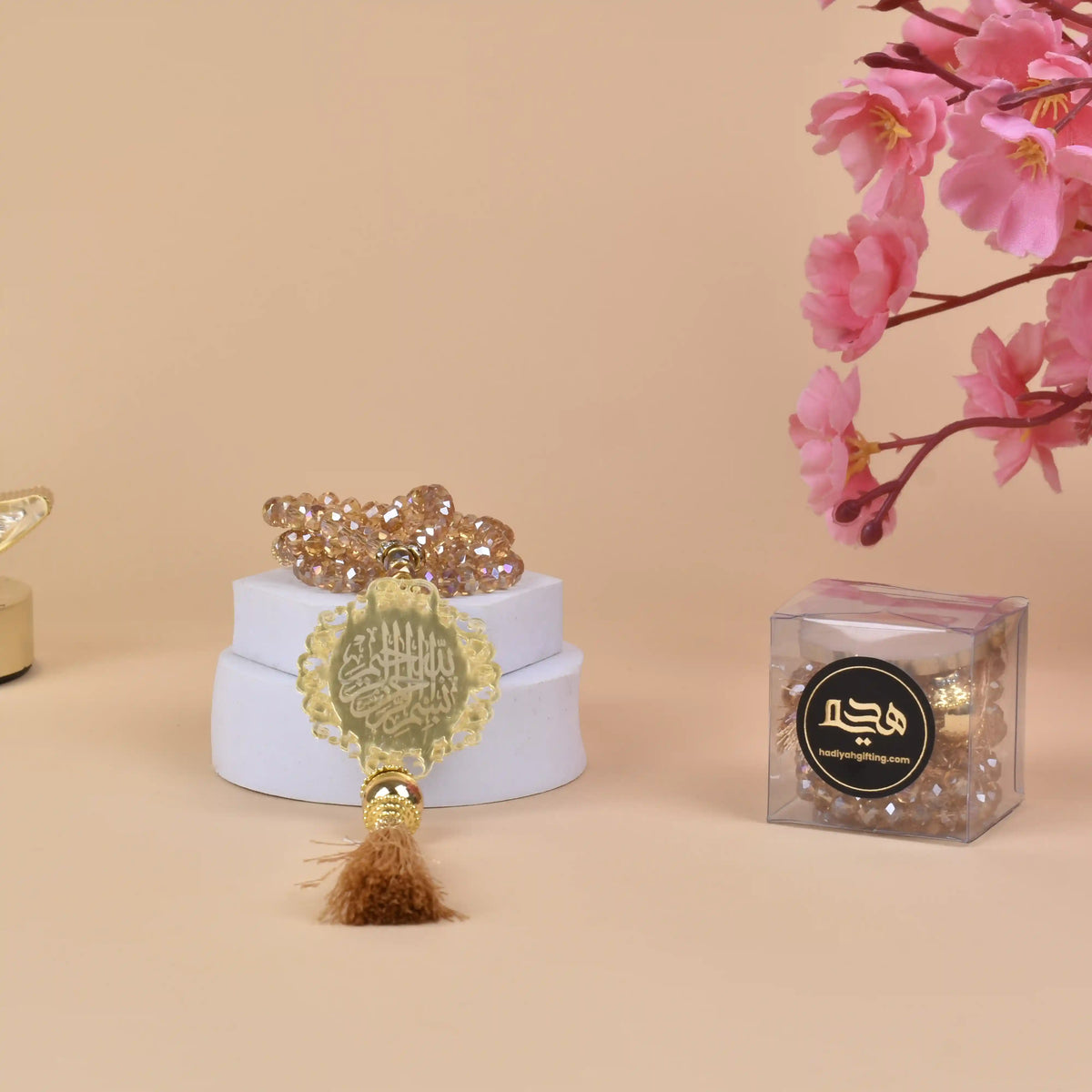 Golden Crystal Tasbeeh with Bismillah charm displayed on a white stand, ideal for Islamic gifting and wedding favors.