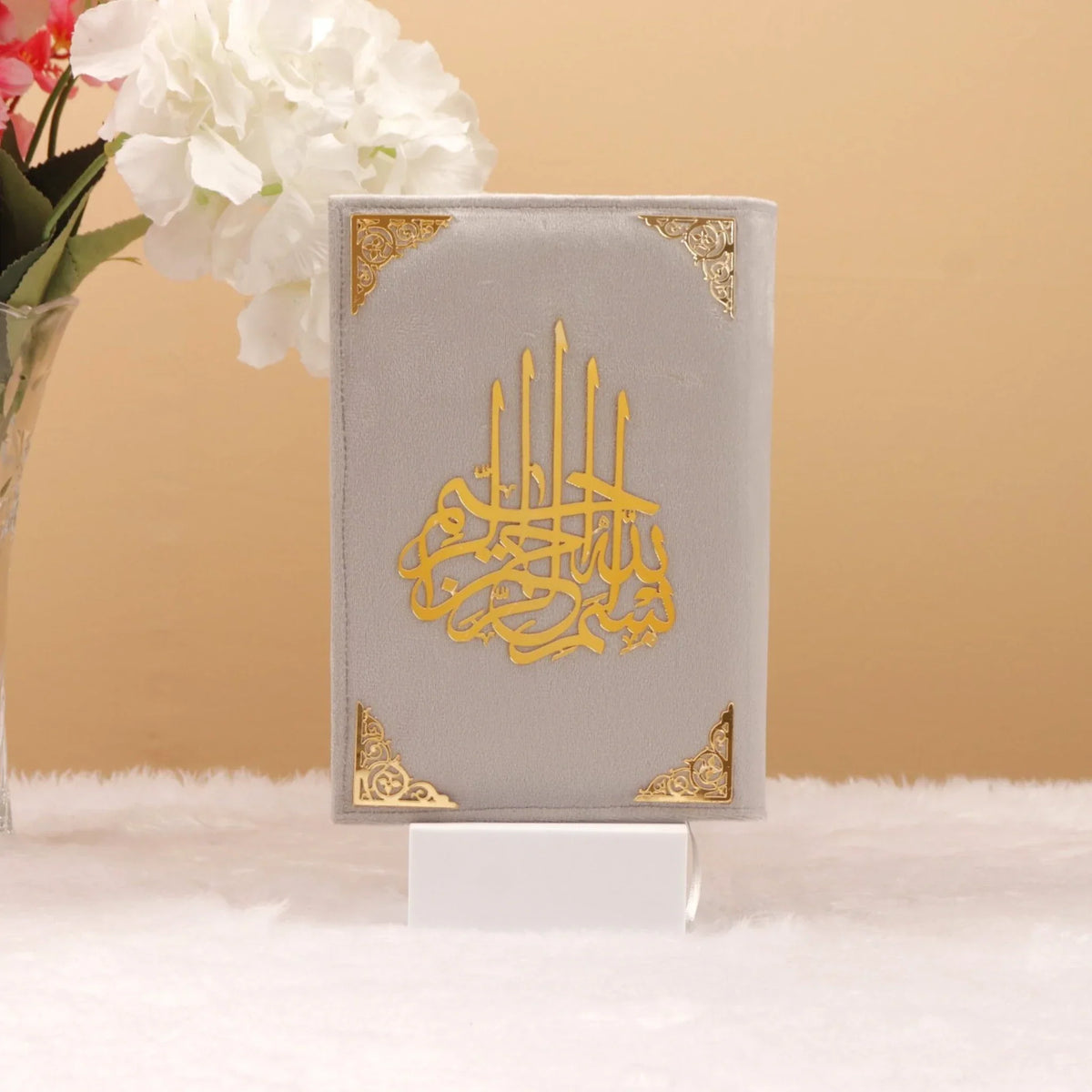 Velvet-covered grey Quran with golden Arabic calligraphy, part of the bridal Quran gift set. A luxurious and spiritual wedding gift.