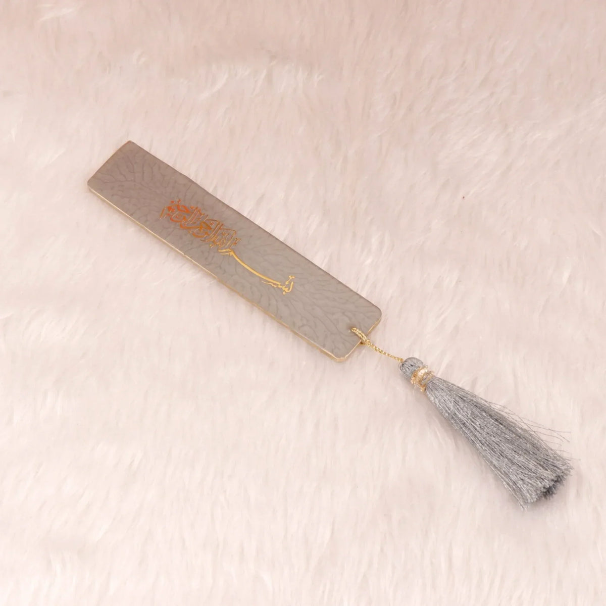 Grey and gold Islamic bookmark with tassel, part of the Grey Stones Quran Gift Hamper. Complements the premium Quran set.