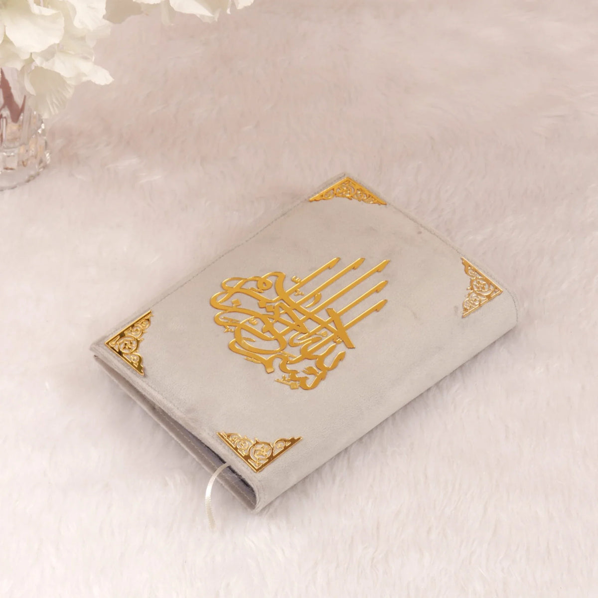 Velvet-covered Quran with gold Arabic calligraphy, included in the Grey Stones Quran Gift Hamper. Elegant and spiritual gift option.