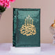 Decorative book with gold text and candle design on a green background, placed on a white surface with pink flowers and a decorative object in the background.