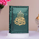 Decorative book with gold text and candle design on a green background, placed on a white surface with pink flowers and a decorative object in the background.