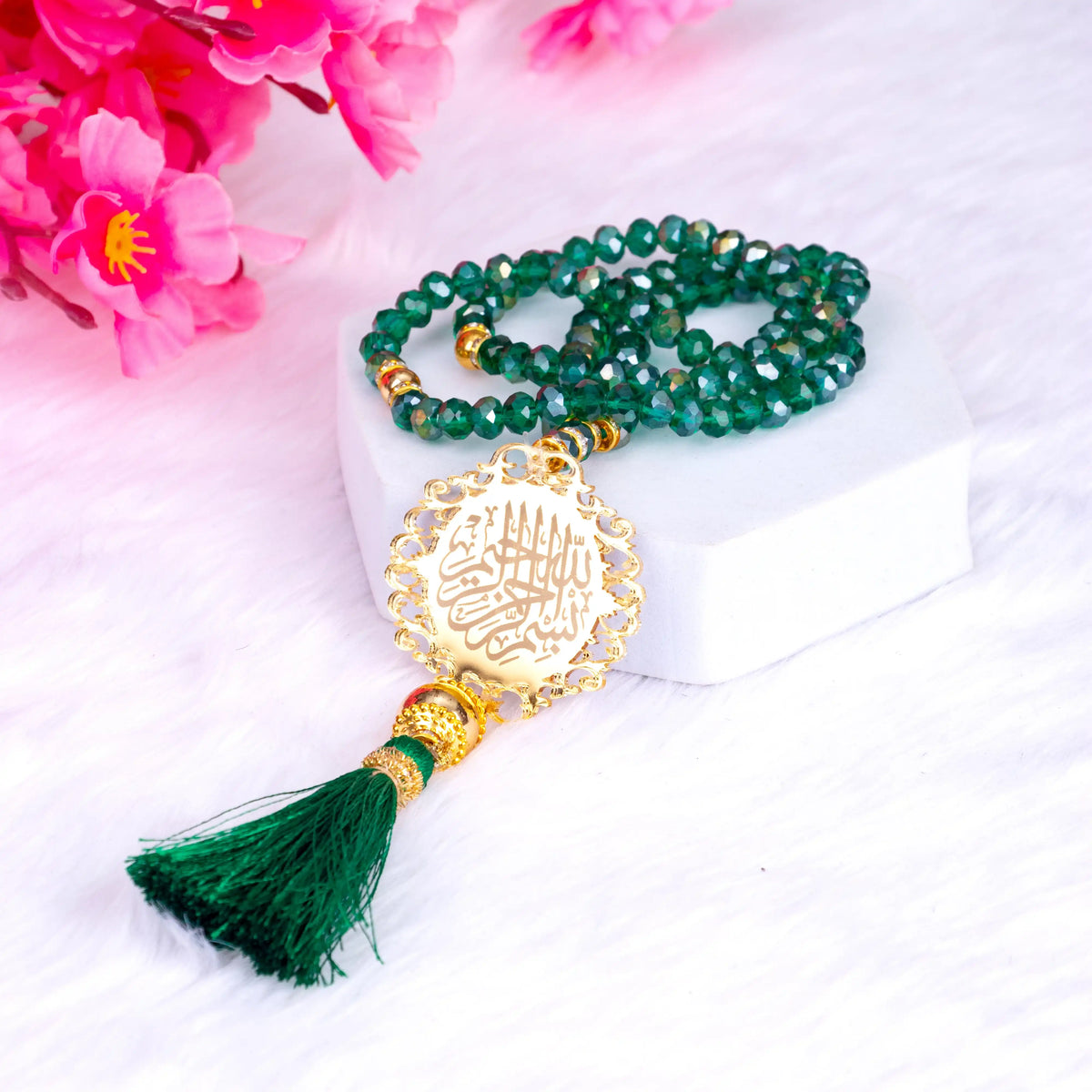 Crystal green tasbeeh with gold Islamic charm and tassel from the Green Stones Sawab-e-Jariya hamper. Elegant spiritual gift accessory.