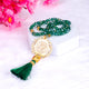 Crystal green tasbeeh with gold Islamic charm and tassel from the Green Stones Sawab-e-Jariya hamper. Elegant spiritual gift accessory.