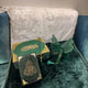 Butterfly Sawab-e-Jariya Gift Set featuring green Quran, tasbeeh, and decorative butterfly stand on a plush sofa. Elegant Eid or wedding gift.