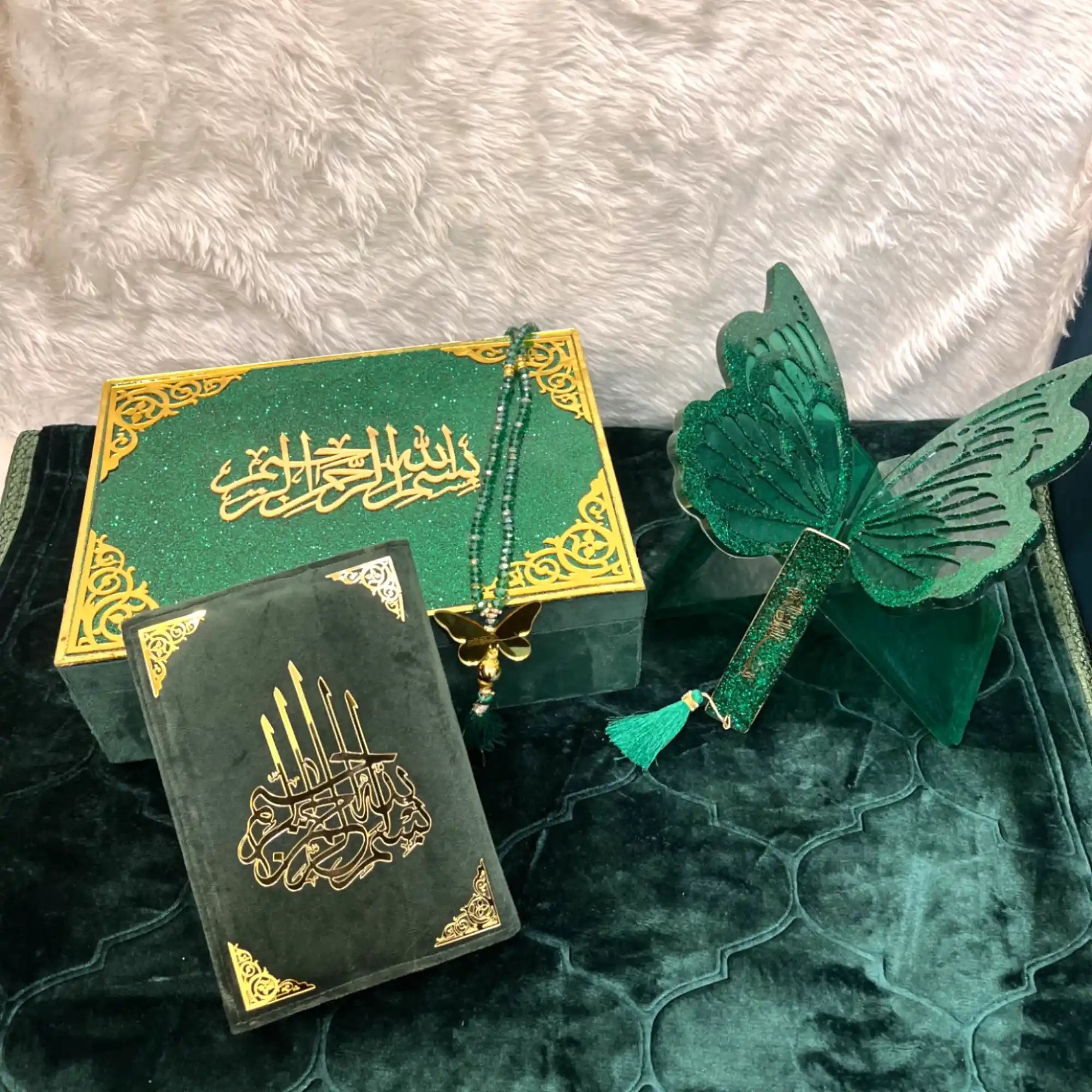 Green and gold decorative items including a butterfly ornament on a textured surface. Main image