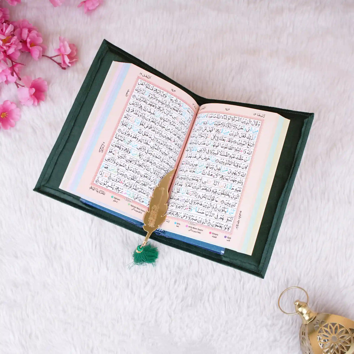 Green Sequence Tilawat-e-Quran open with golden feather bookmark, showcasing Arabic script and elegant presentation.