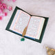 Green Sequence Tilawat-e-Quran open with golden feather bookmark, showcasing Arabic script and elegant presentation.