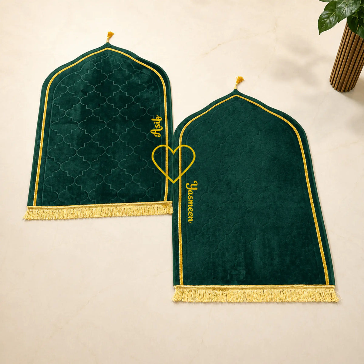 Personalized green velvet prayer mats with names 'Aasiy' and 'Yasmeen' from the Green Stones Sawab-e-Jariya bridal collection. Couple prayer set.