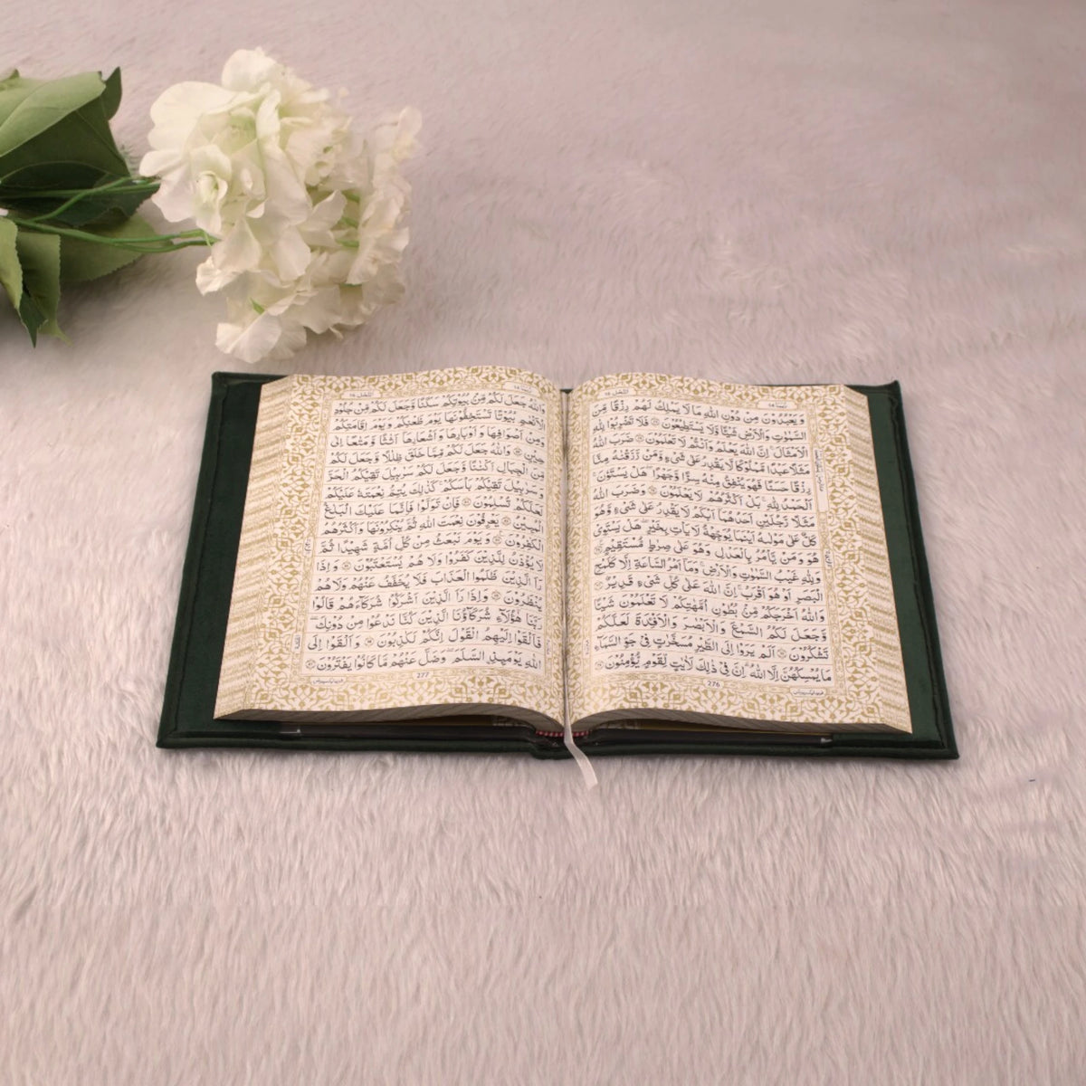 Open Quran with gold-embellished border from the Green Flakes Sawab-E-Jariya Hamper, perfect for ceremonial gifting.