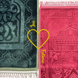 Two prayer mats, one green and one red with intricate patterns, on a white background.