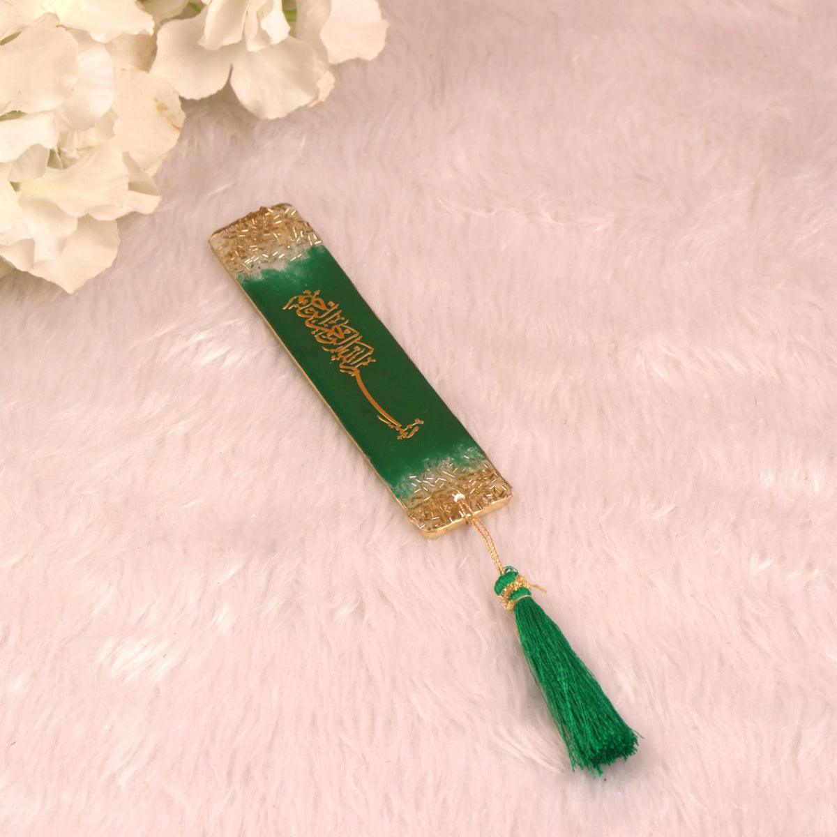 Close-up of green Islamic bookmark with tassel from the Sawab-E-Jariya Hamper, ideal for Quran reading and spiritual gifts.