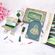 Decorative items with Arabic calligraphy on a white surface with pink flowers.
