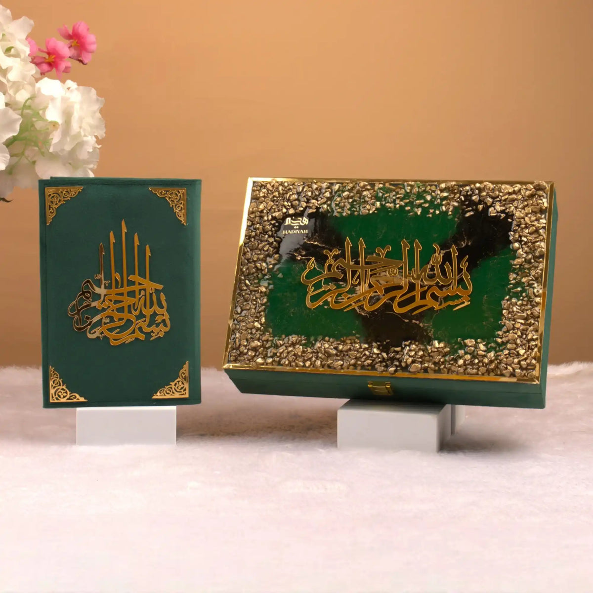 Two decorative boxes with Arabic calligraphy on a neutral background