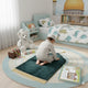 Child praying on Green Kids Dome Prayer Rug in a themed bedroom; portable and soft prayer mat designed for kids aged 3-10.