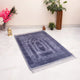 Grey Rectangle Janamaz - Custom Prayer Rug with plush velvet texture, ideal for Ramadan and Eid gifting, placed in a serene indoor setting.