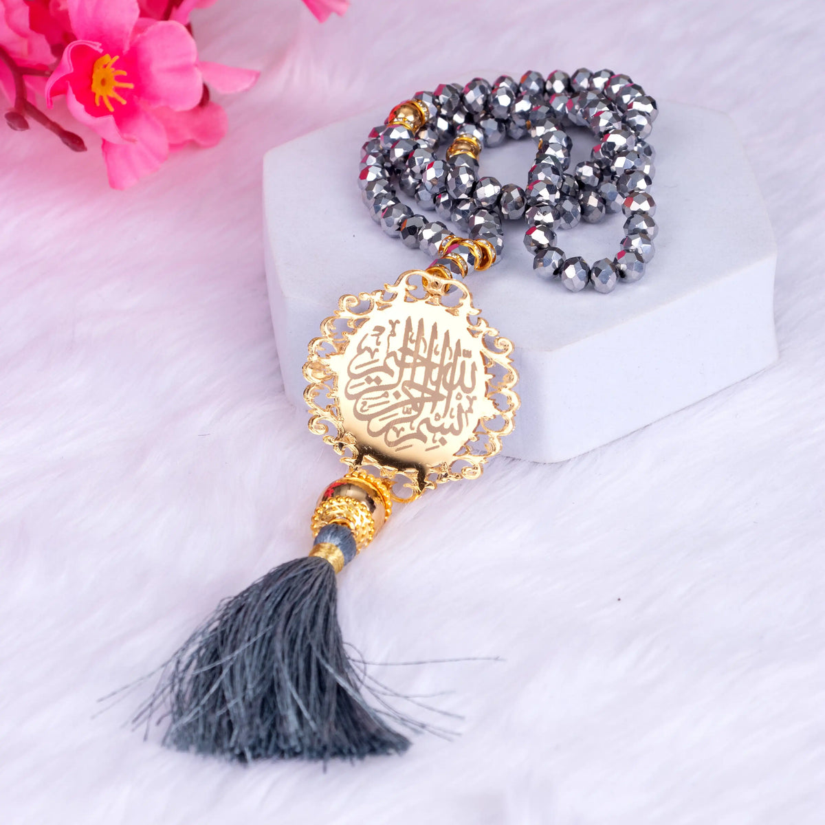 Grey Tasbeeh with golden Islamic medallion and tassel from the Velvet Quran Rehal Hamper. A spiritual accessory for daily prayer and gifting.