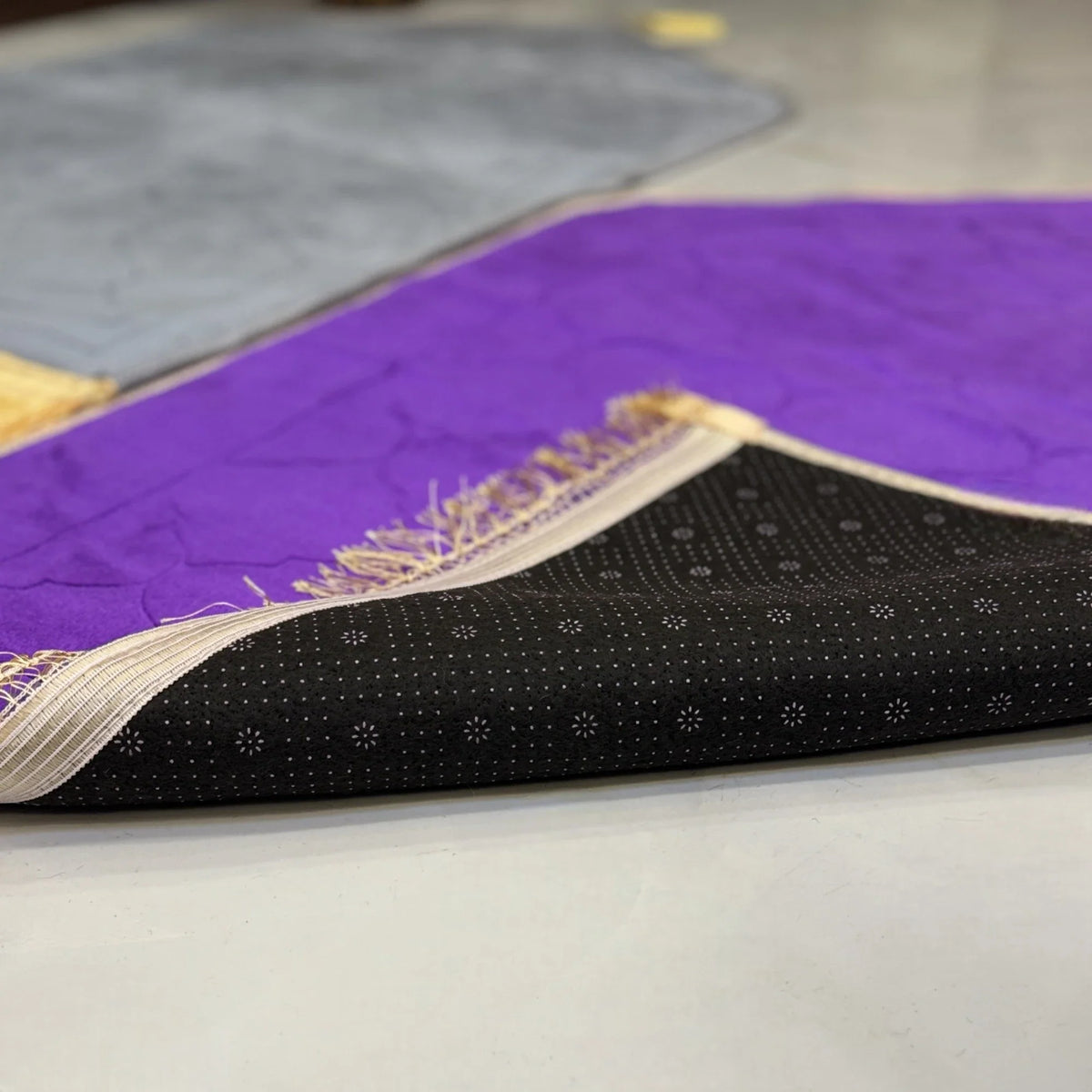 Underside of Couple Janamaz Set showing anti-slip black base with dotted pattern, ensuring stability during prayer on smooth surfaces.