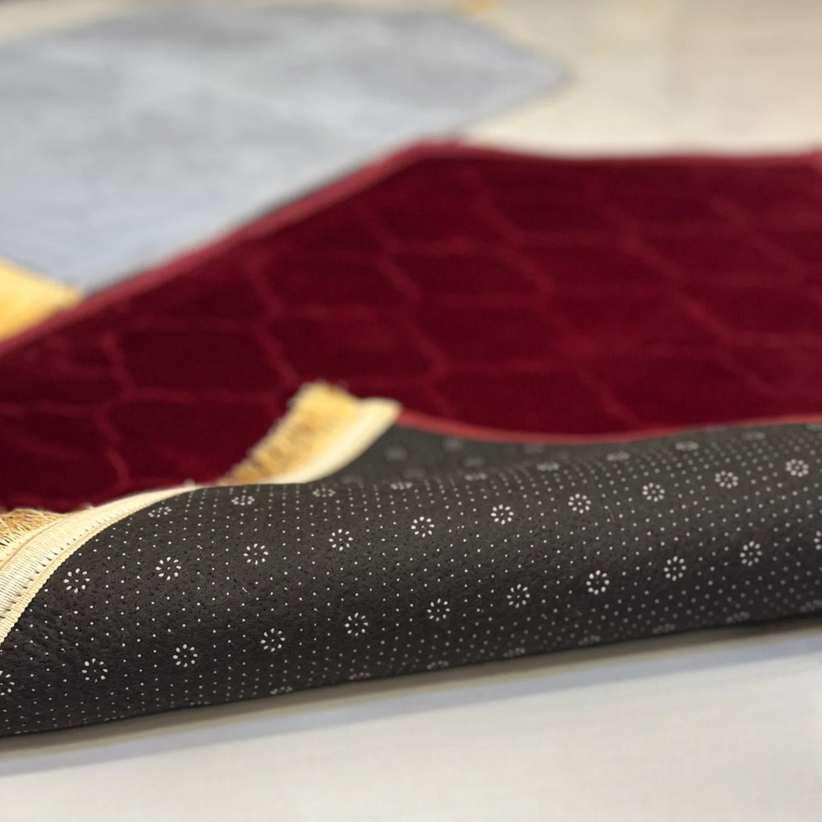 Underside of Grey & Maroon Dome Janamaz Set showing anti-slip backing and fine stitching, designed for stability and daily use in prayers.