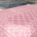 Detailed view of pink prayer rug from the Grey & Pink Rectangle Prayer Mat - Couple Prayer Mat Set, highlighting soft fabric and intricate Islamic pattern.
