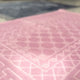 Detailed view of pink prayer rug from the Grey & Pink Rectangle Prayer Mat - Couple Prayer Mat Set, highlighting soft fabric and intricate Islamic pattern.
