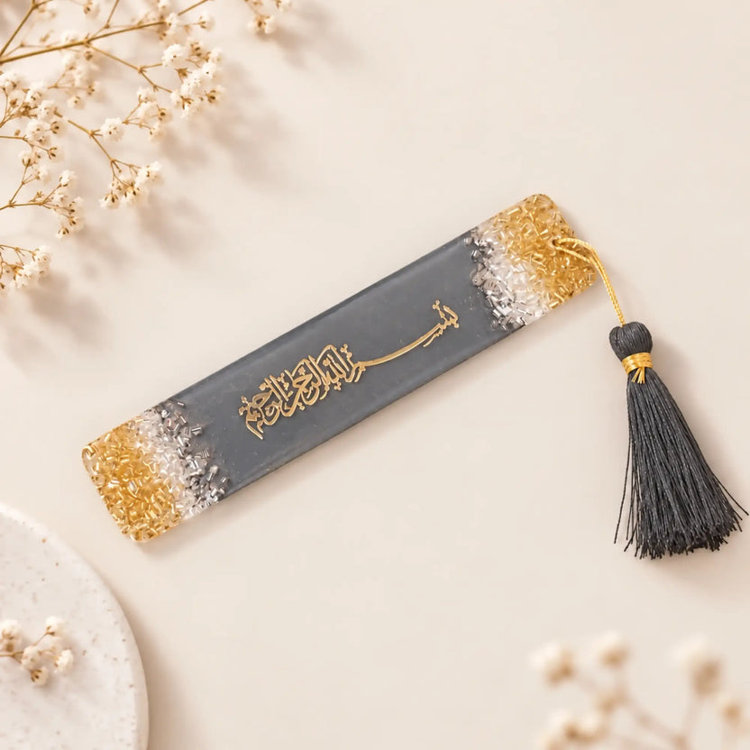 Decorative bookmark with tassel on a fluffy white surface with pink flowers. Main image