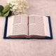 Open Quran with traditional Arabic script from the Blue Sequence Rehal Hamper, ideal for recitation and religious gifting.