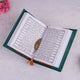 Open book with a feather on a textured surface