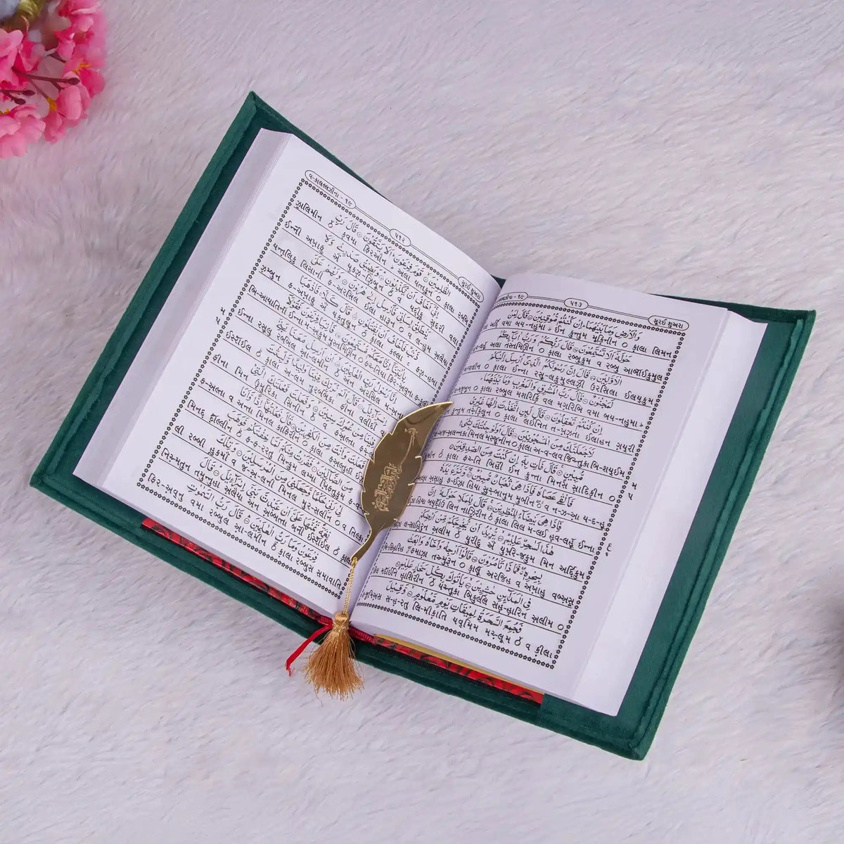 Open book with a feather on a textured surface