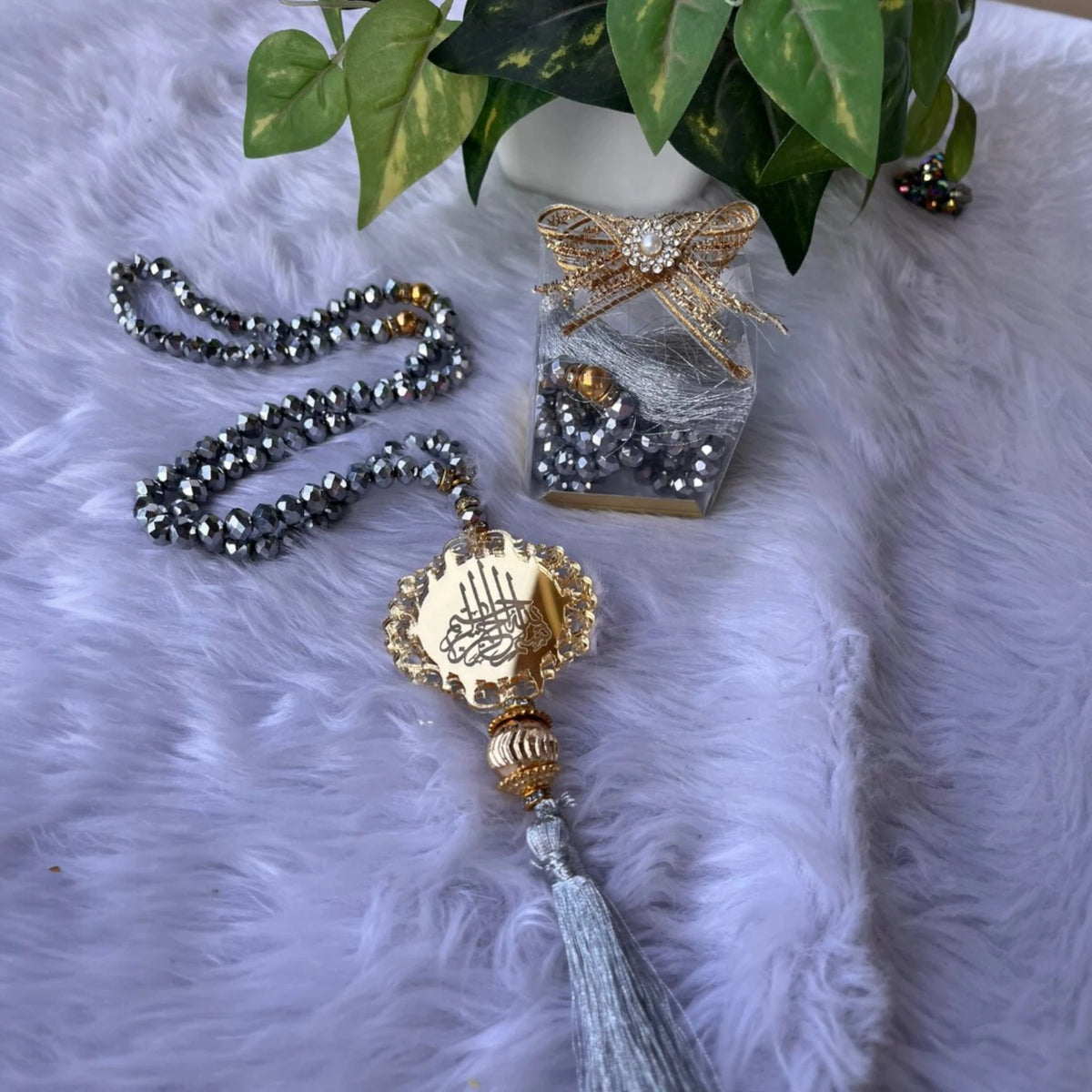 Silver-toned 100 Beads Crystal Tasbeeh with gold pendant and grey tassel, presented with decorative gift box, perfect for Ramadan prayer gifting.