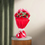 8 Red Roses Bouquet wrapped in red paper with white ribbon, displayed on a marble-top table. Romantic gift for anniversaries or Valentine's Day.