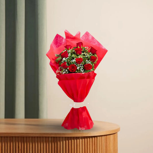 Blooming Insight - Bright Bloom Bouquet with 10 red roses and white fillers, wrapped in elegant red 2-layer fabric, displayed on a wooden table.